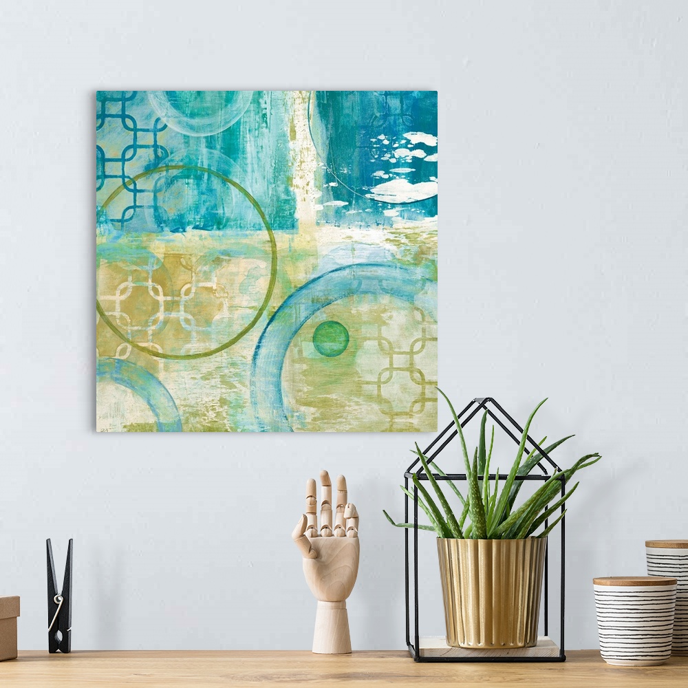 A bohemian room featuring Square abstract painting using different shapes with teal and yellow hues.