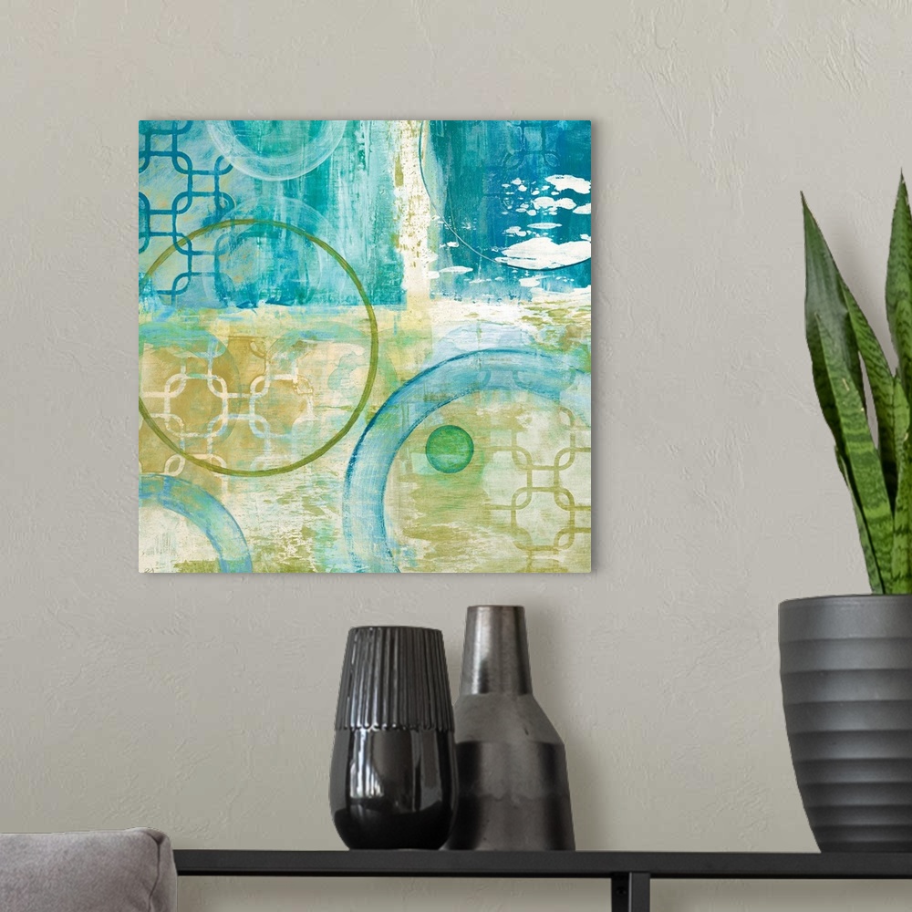 A modern room featuring Square abstract painting using different shapes with teal and yellow hues.