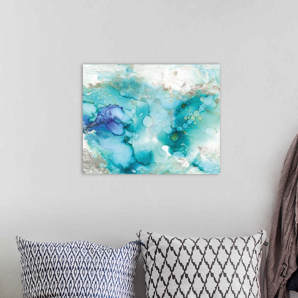 A bohemian room featuring Large abstract watercolor painting in shades of blue, grey, and green marbling together.