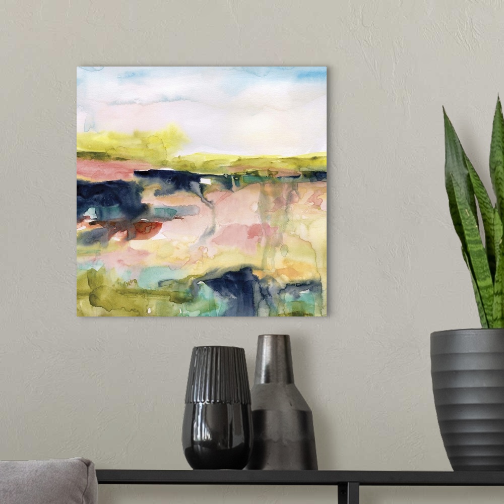 A modern room featuring A square watercolor abstract painting with bold and bright colors blending together.