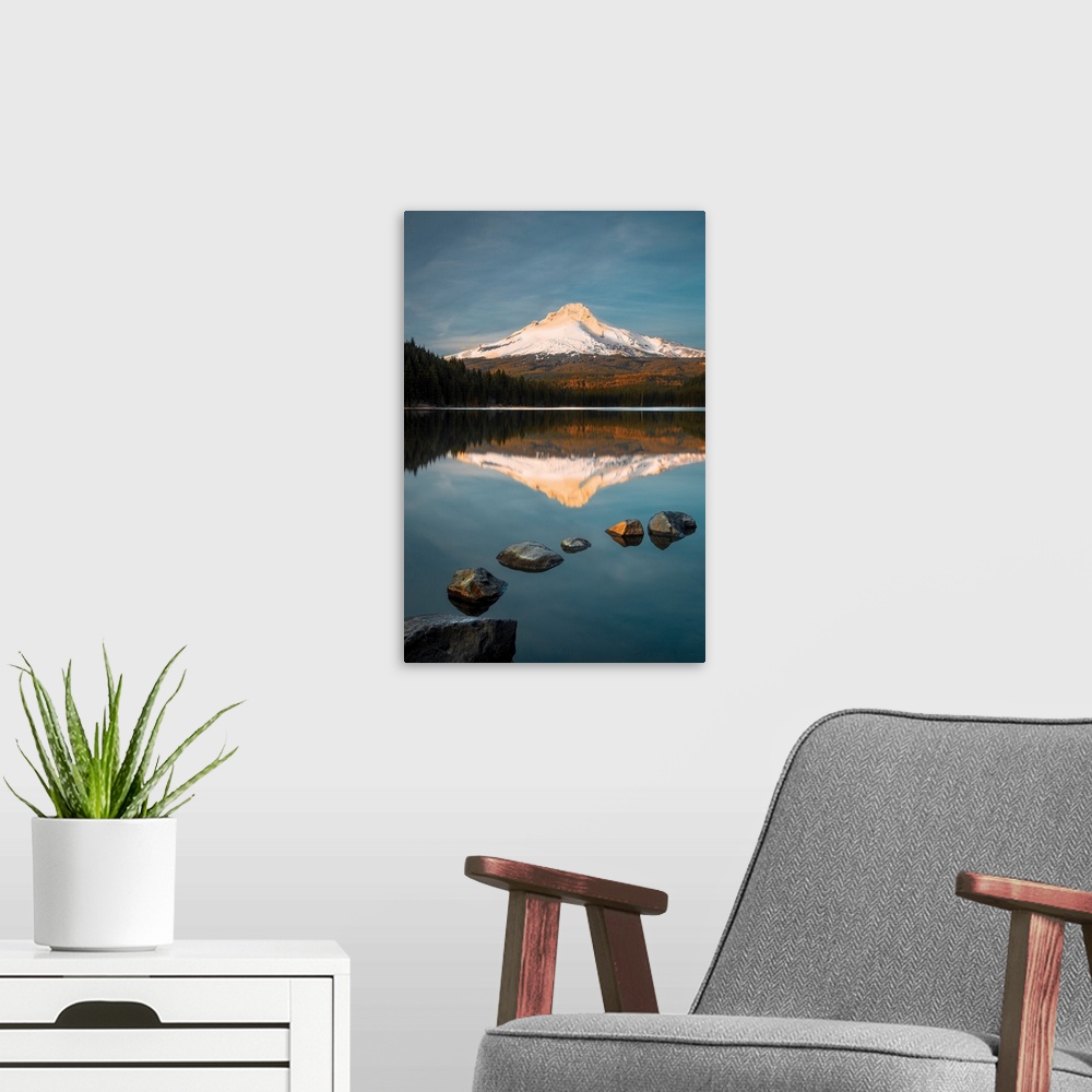 A modern room featuring Snow-capped Mount Hood reflected in the lake below at sunset, Oregon.