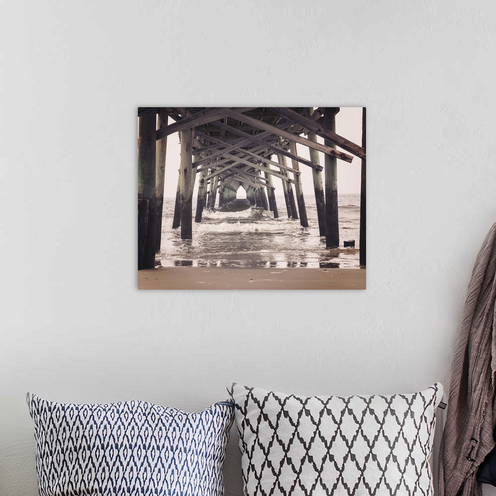 A bohemian room featuring Photograph, with a faded look, of under a pier at the beach.