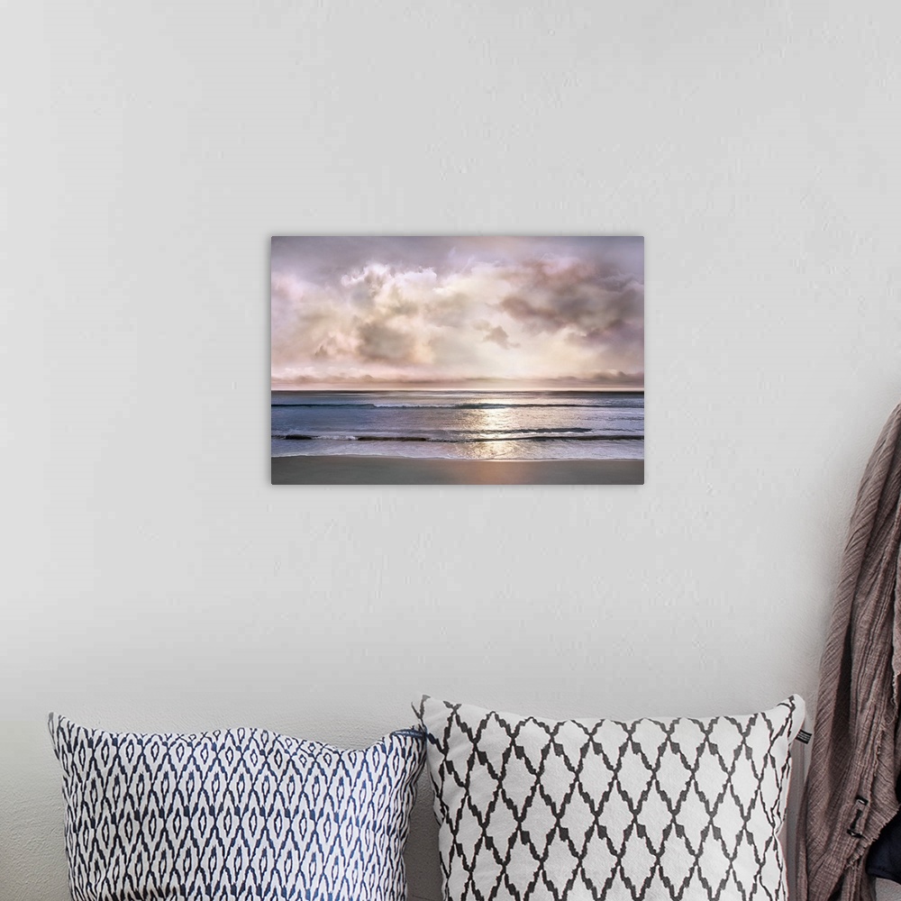 A bohemian room featuring Landscape photograph where the ocean and shore meet with a light pink and purple sunset pushing t...