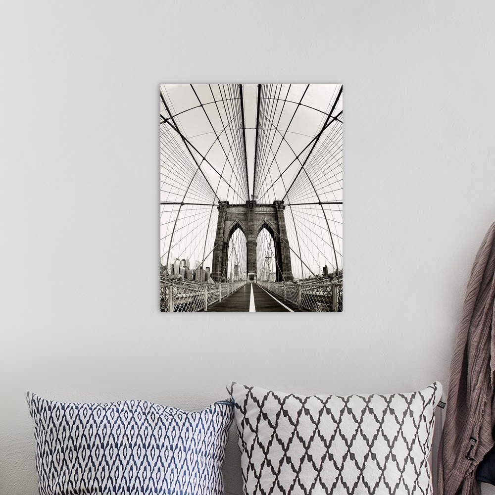A bohemian room featuring Symmetric abstract photograph of the Brooklyn Bridge with a vintage color to it.