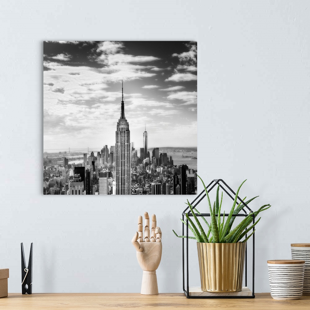 A bohemian room featuring Black and white square photograph of New York City from a bird's eye view, highlighting the Empir...