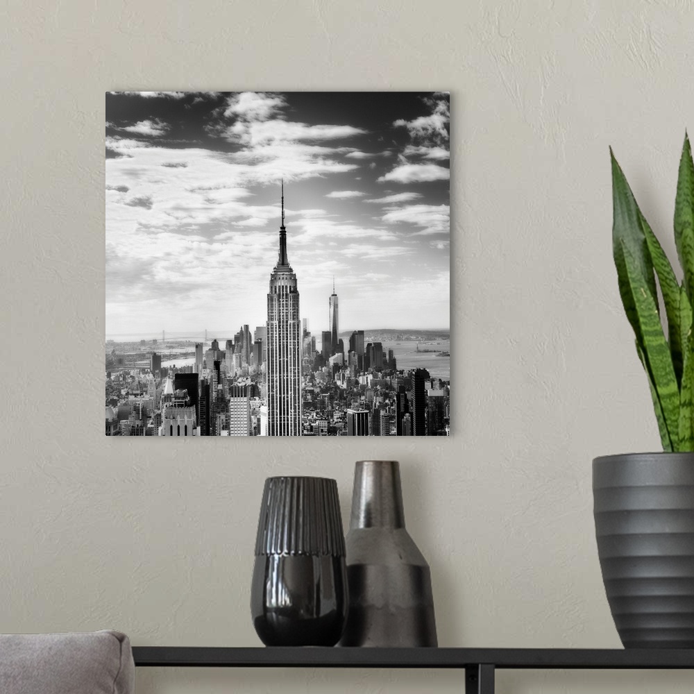 A modern room featuring Black and white square photograph of New York City from a bird's eye view, highlighting the Empir...