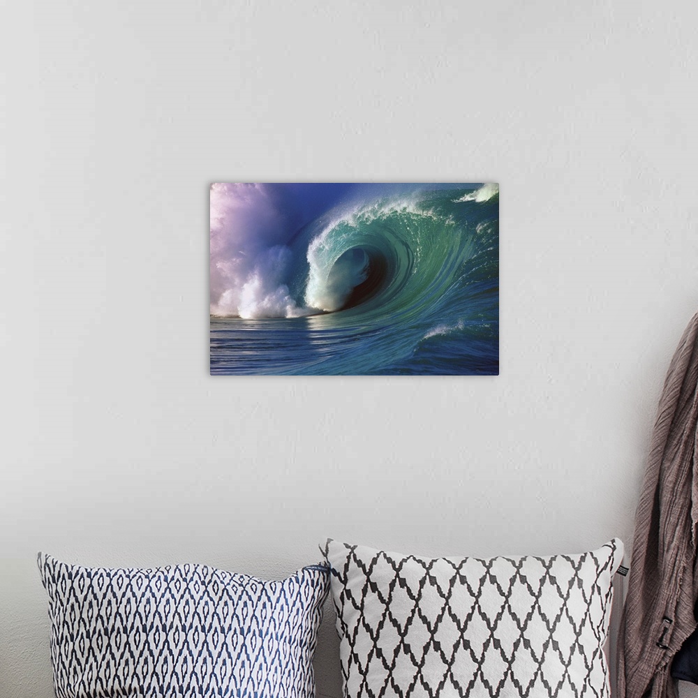 A bohemian room featuring A photograph of a big wave with blue, green, and magenta hues.