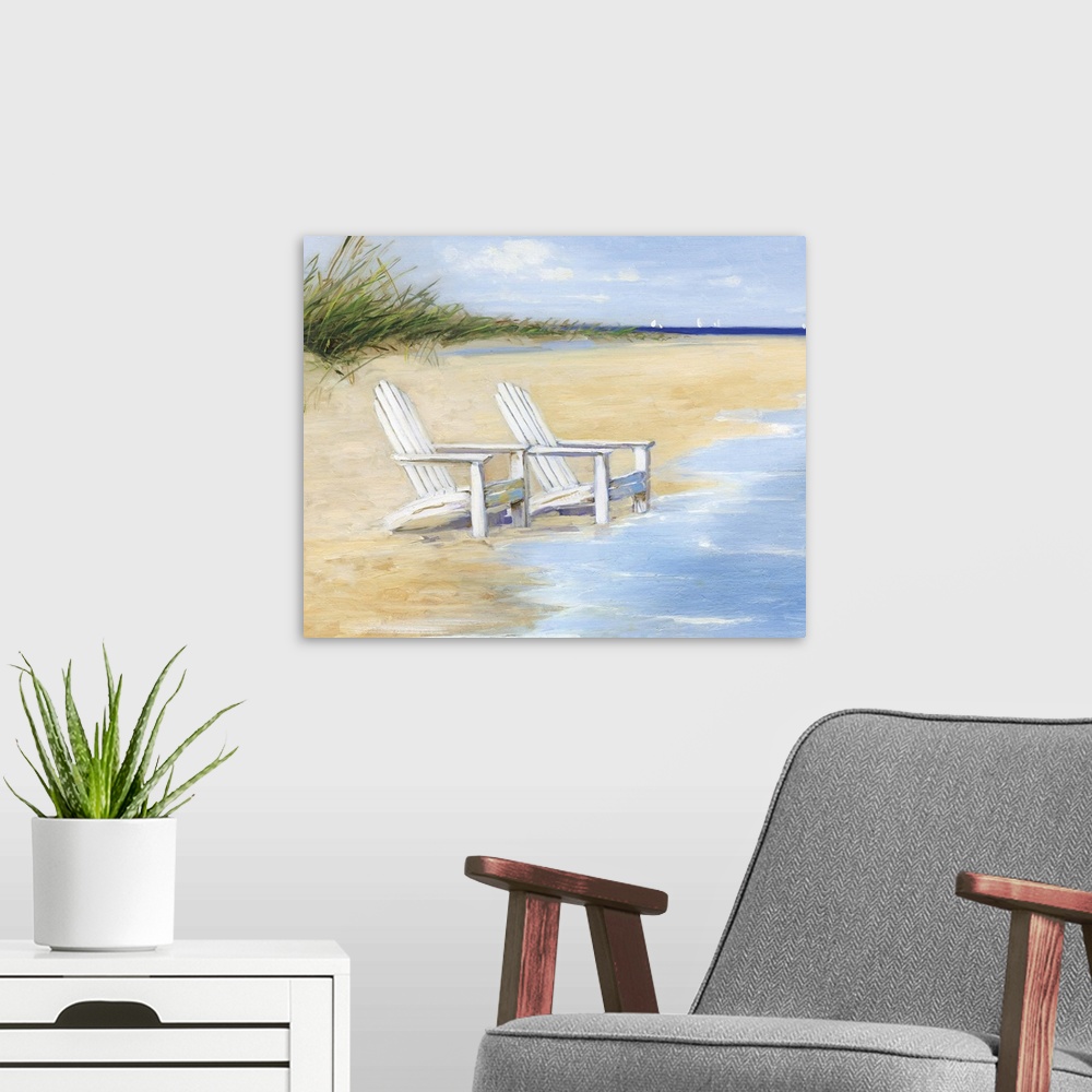 A modern room featuring Contemporary painting of two white chairs on a sandy beach with the tide coming in.