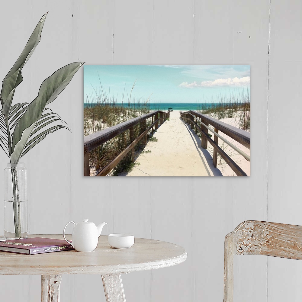 A farmhouse room featuring A photo of sandy boardwalk surrounded by grasses that reaches into the beach with an umbrella and...
