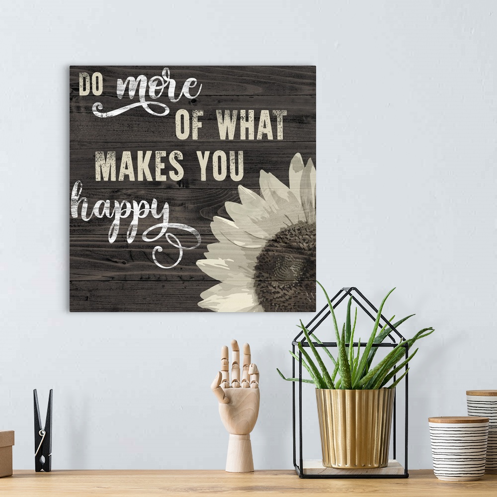 A bohemian room featuring Decorative artwork of a sunflower and the text 'Do More Of what Makes You Happy' on a wood backdrop.