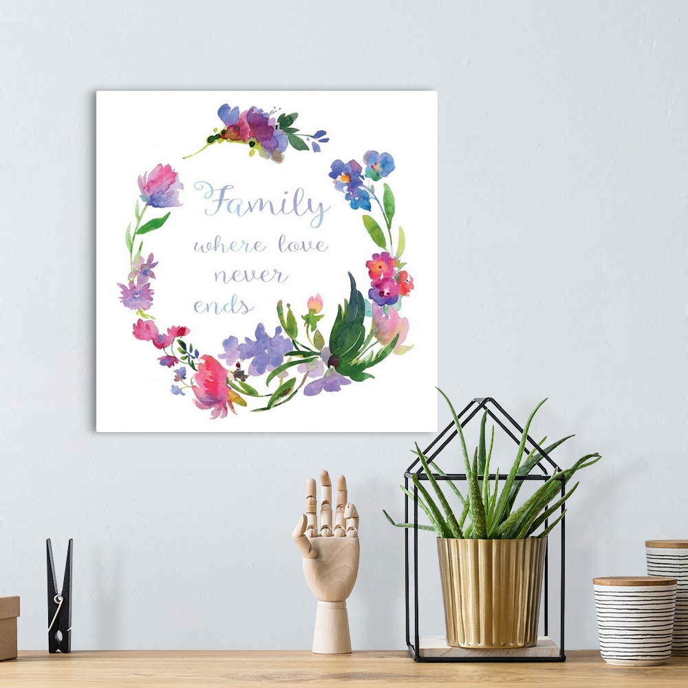 A bohemian room featuring "Family Where Love Never Ends" written in cursive inside of a watercolor floral wreath on a white...
