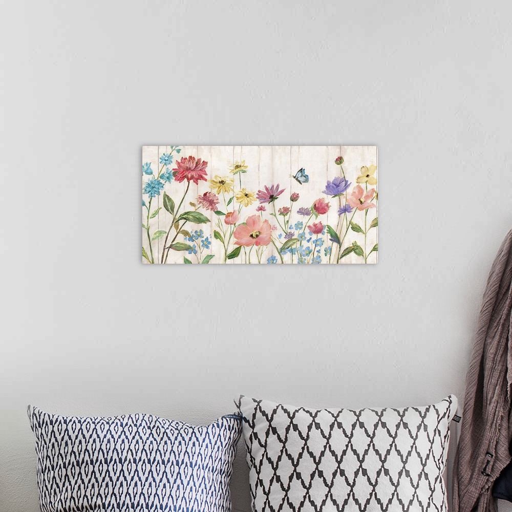 A bohemian room featuring Large painting of colorful wildflowers and a butterfly flying overhead on a faux wood background ...