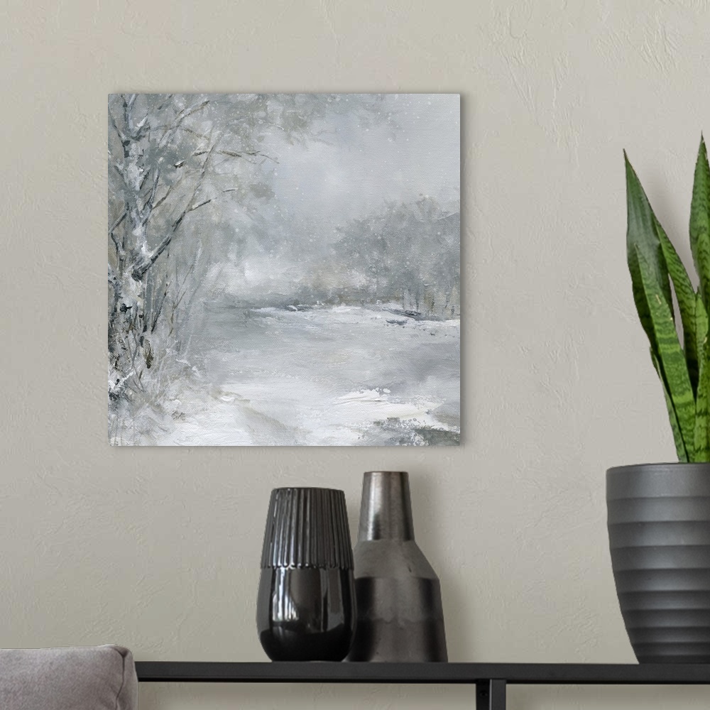 A modern room featuring A muted snow scene of a field outlined by a forest with snow falling.