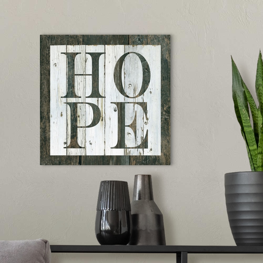 A modern room featuring Decorative artwork of a white square and the word 'Hope' in it against of rustic wood background.