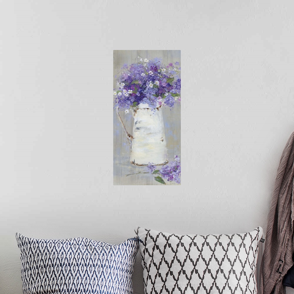 A bohemian room featuring A contemporary still life painting of a bouquet of purple and pink flowers arranged in a white pi...