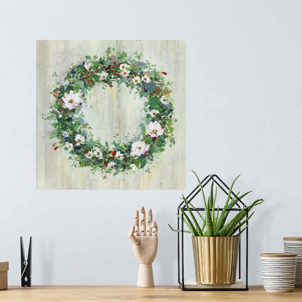A bohemian room featuring A contemporary painting of a green wreath covered in white and red flowers on a wood background.