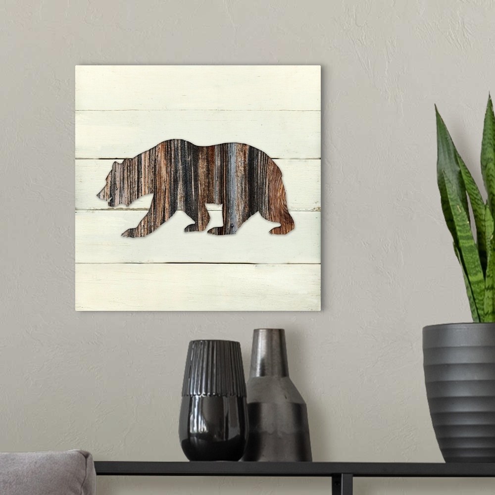 A modern room featuring Square decor of a dark brown wooden silhouette of a bear on a white wooden plant background.