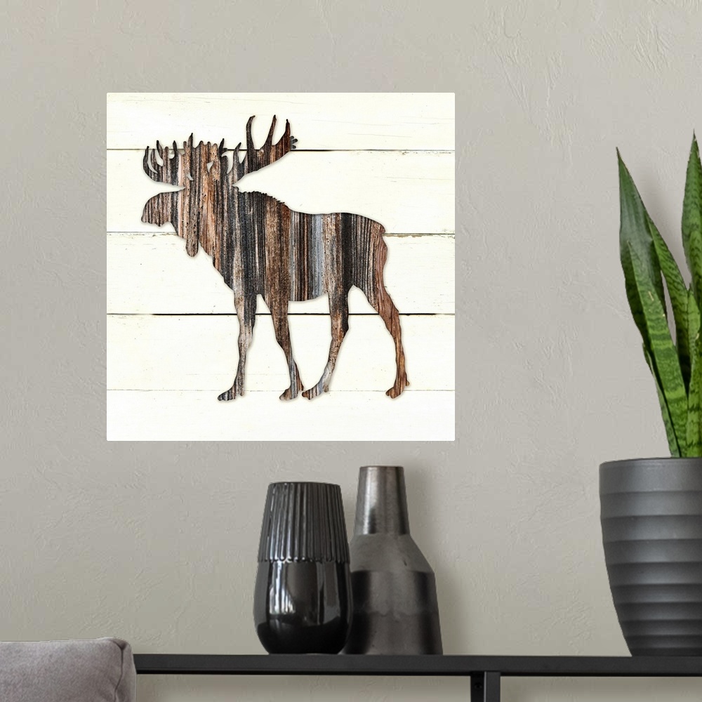 A modern room featuring Square decor of a dark brown wooden silhouette of a moose on a white wooden plant background.