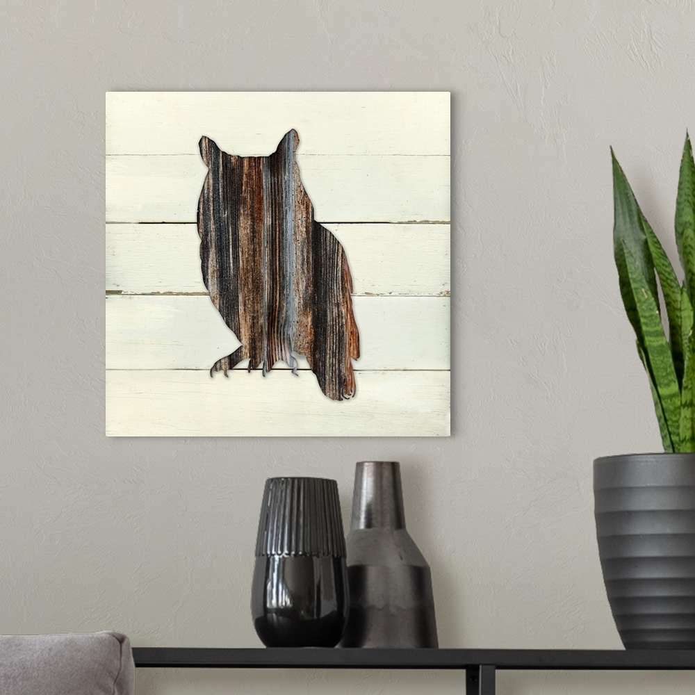 A modern room featuring Square decor of a dark brown wooden silhouette of a owl on a white wooden plant background.