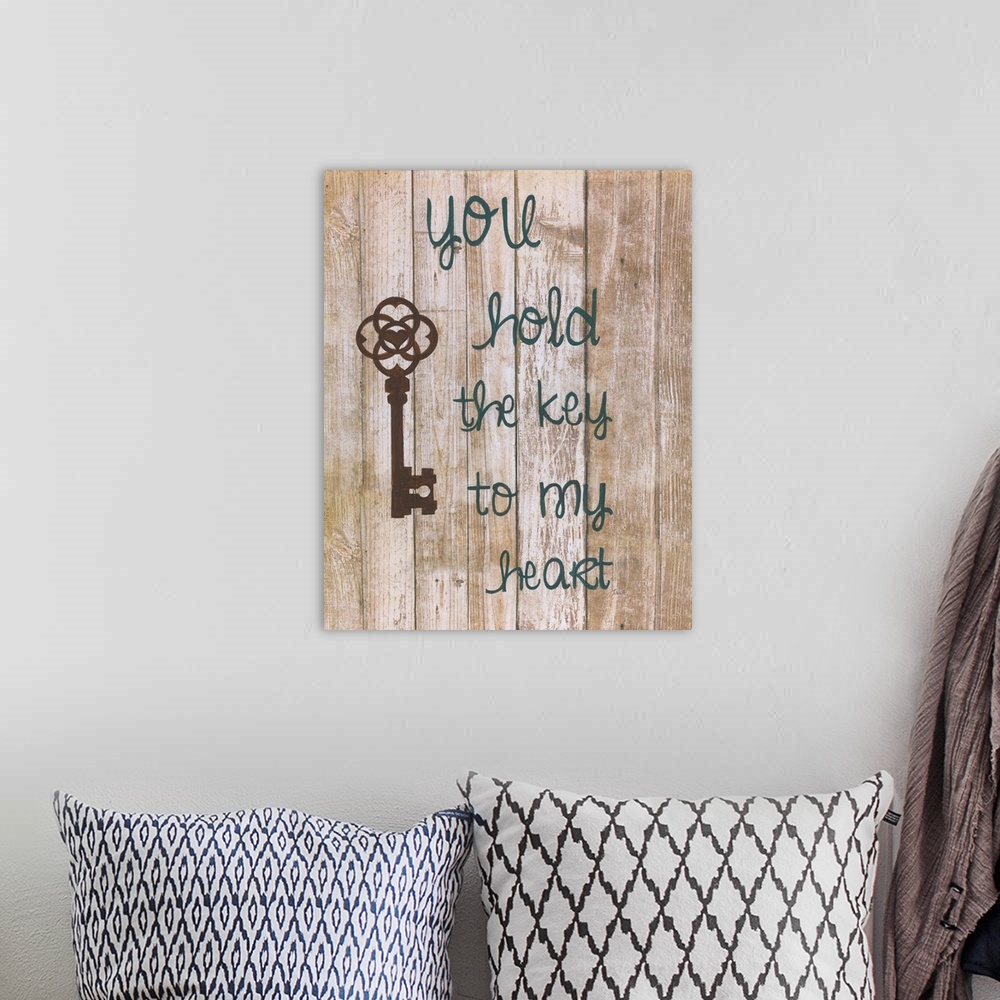 A bohemian room featuring A decorative painting that has an antique key and the saying ?you hold the key to my heart? paint...