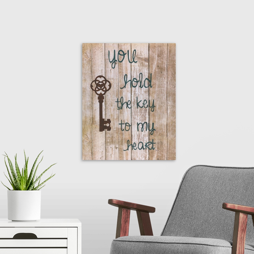 A modern room featuring A decorative painting that has an antique key and the saying ?you hold the key to my heart? paint...