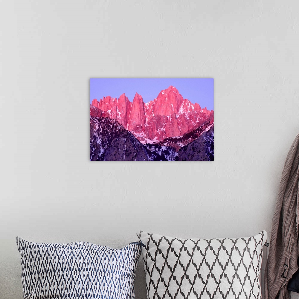 A bohemian room featuring Pink and purple toned photograph of rocky mountain peaks on Mt. Whitney at sunrise.