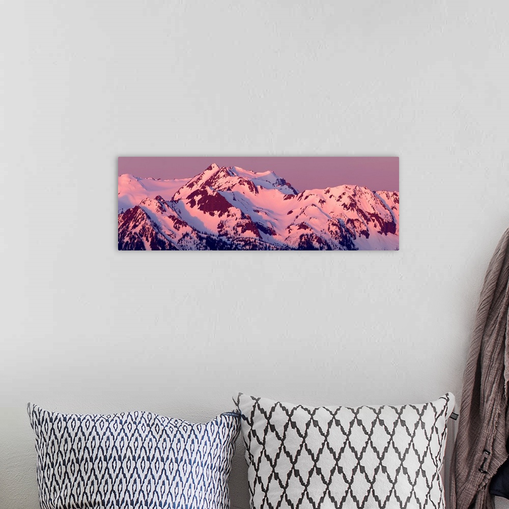 A bohemian room featuring Panoramic photograph of pink alpenglow on top of Mount Olympus, Washington.