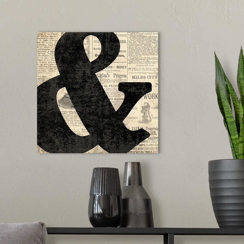 A modern room featuring Square decor with a large black ampersand on a newspaper background.