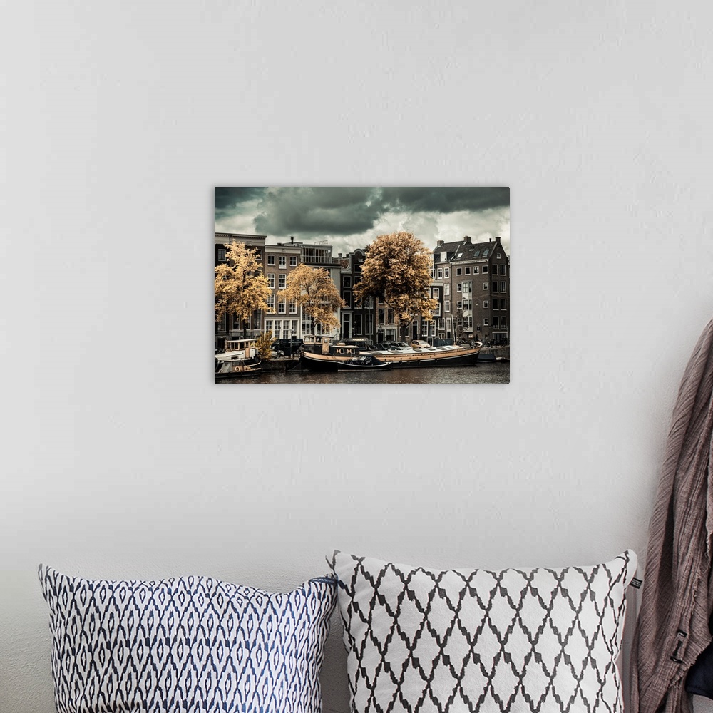 A bohemian room featuring Boats docked along the canal in Amsterdam in the fall.