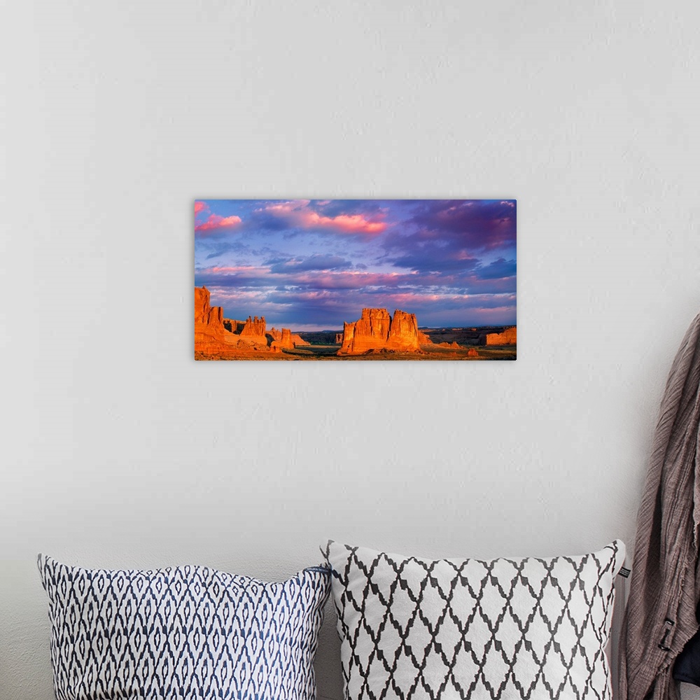 A bohemian room featuring Tall rock formations illuminated at sunset in Arches National Park, Utah.