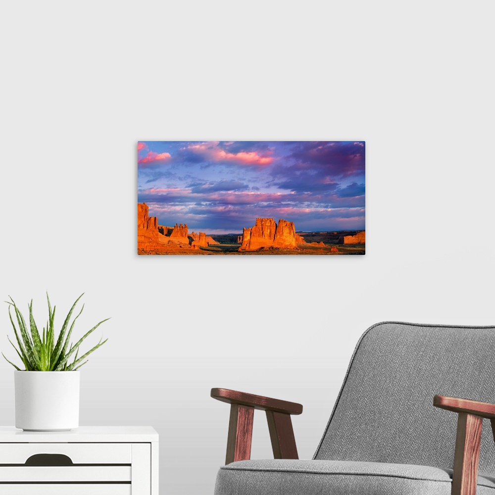 A modern room featuring Tall rock formations illuminated at sunset in Arches National Park, Utah.