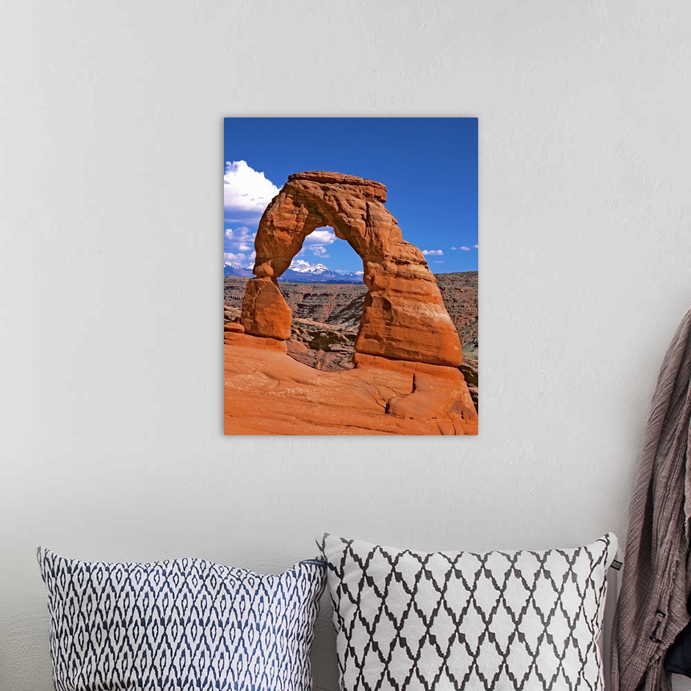 A bohemian room featuring Bright red natural arch on a cliff in Arches National Park, Utah.