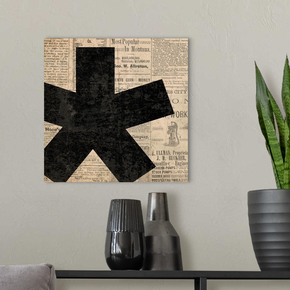 A modern room featuring Square decor with a large black asterisk on a newspaper background.