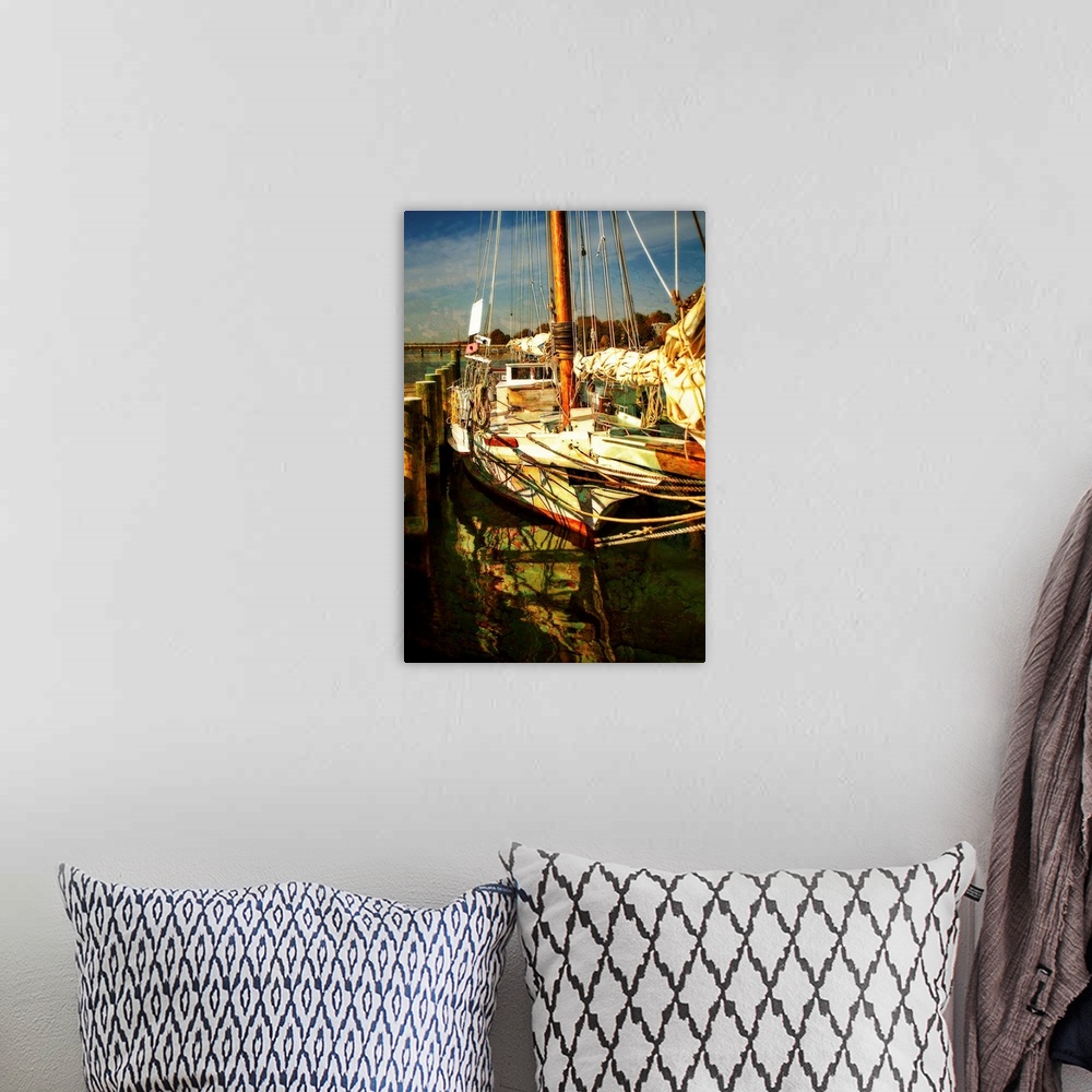 A bohemian room featuring Photograph of a sailboat docked with beautiful light.