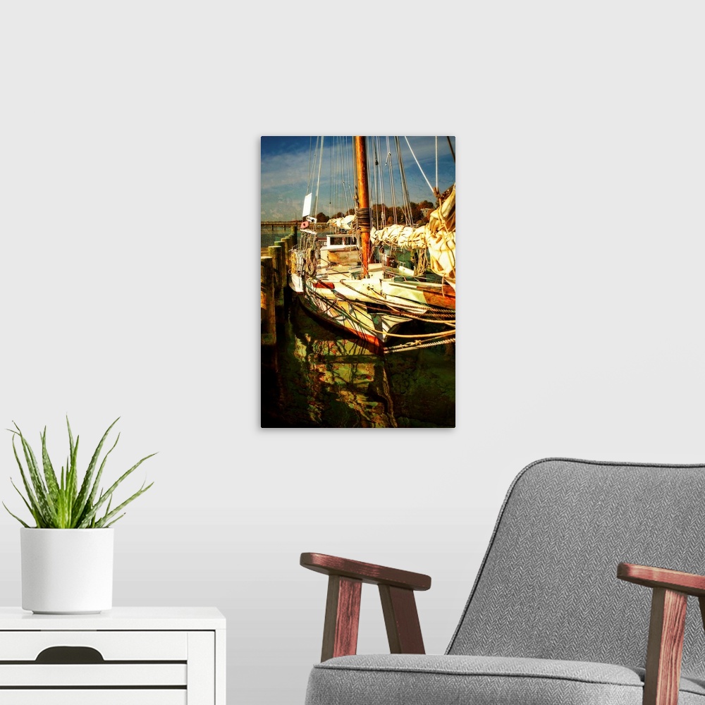 A modern room featuring Photograph of a sailboat docked with beautiful light.