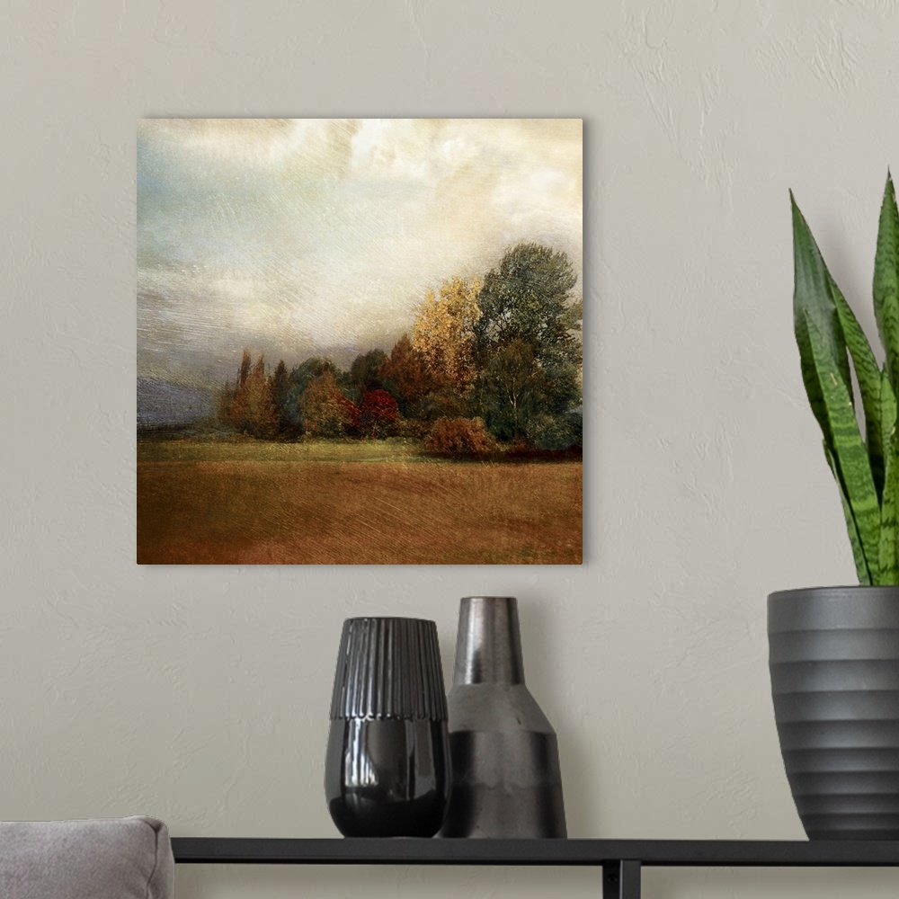 A modern room featuring Square panting on canvas of a field with an autumn colored forest in the background.