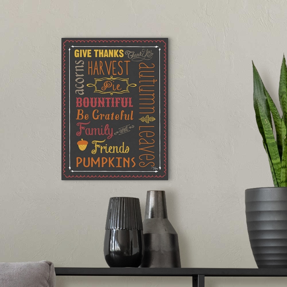 A modern room featuring Typography sign with Autumn themed words and colors.