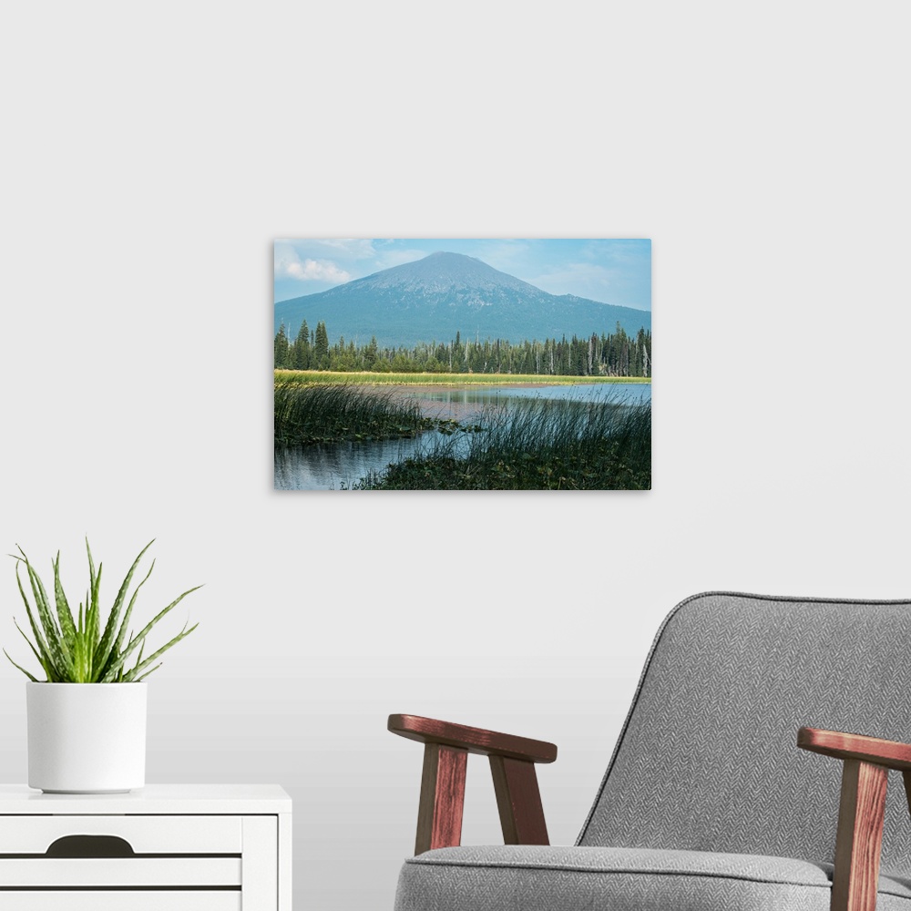 A modern room featuring Landscape photograph of water in front of Mount Bachelor in Oregon.