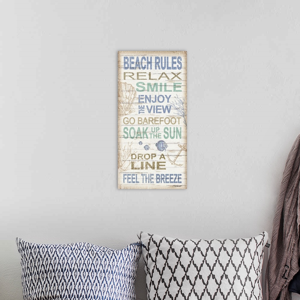 A bohemian room featuring Beach themed decor with a set of beach rules written on a white wooden background with various un...