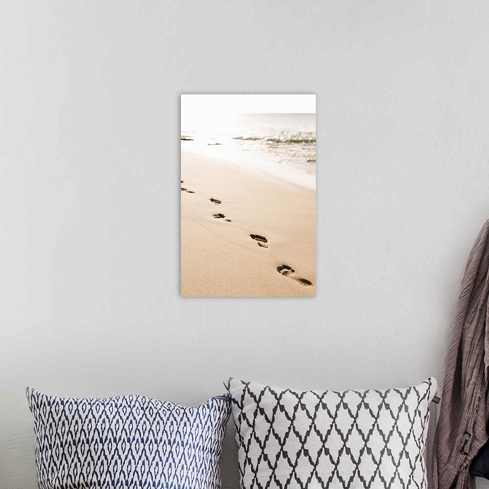A bohemian room featuring Photograph of a line of footprints in the sand in front of the ocean.