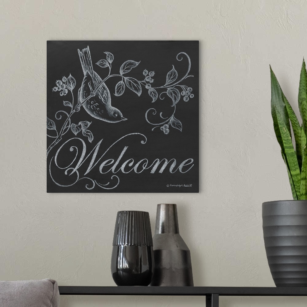 A modern room featuring Square chalkboard "Welcome" sign with white chalk illustration of a bird perched on a branch with...