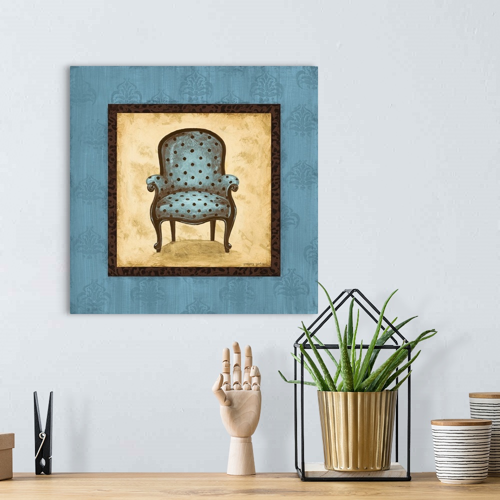 A bohemian room featuring Square painting with a blue and brown polka dotted chair in the center with a tan background and ...