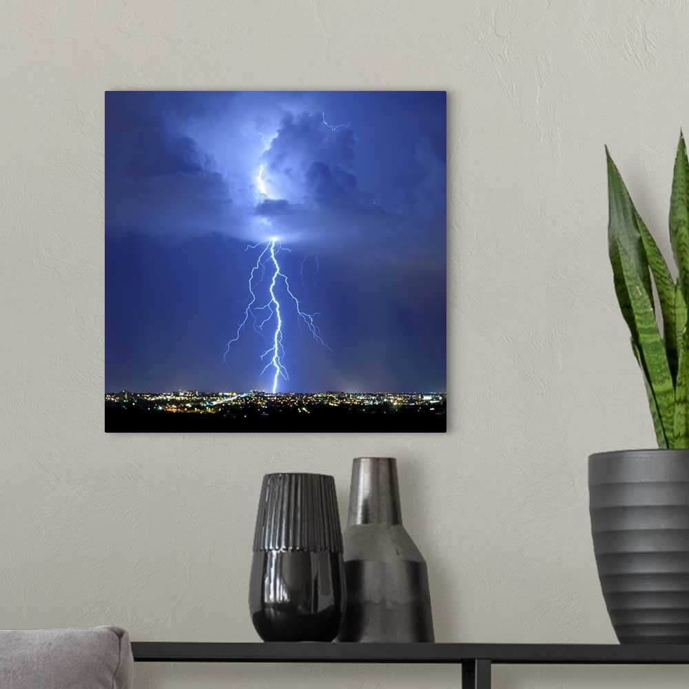 A modern room featuring Square photograph of lightning bolts in a blue sky above an Arizona city.