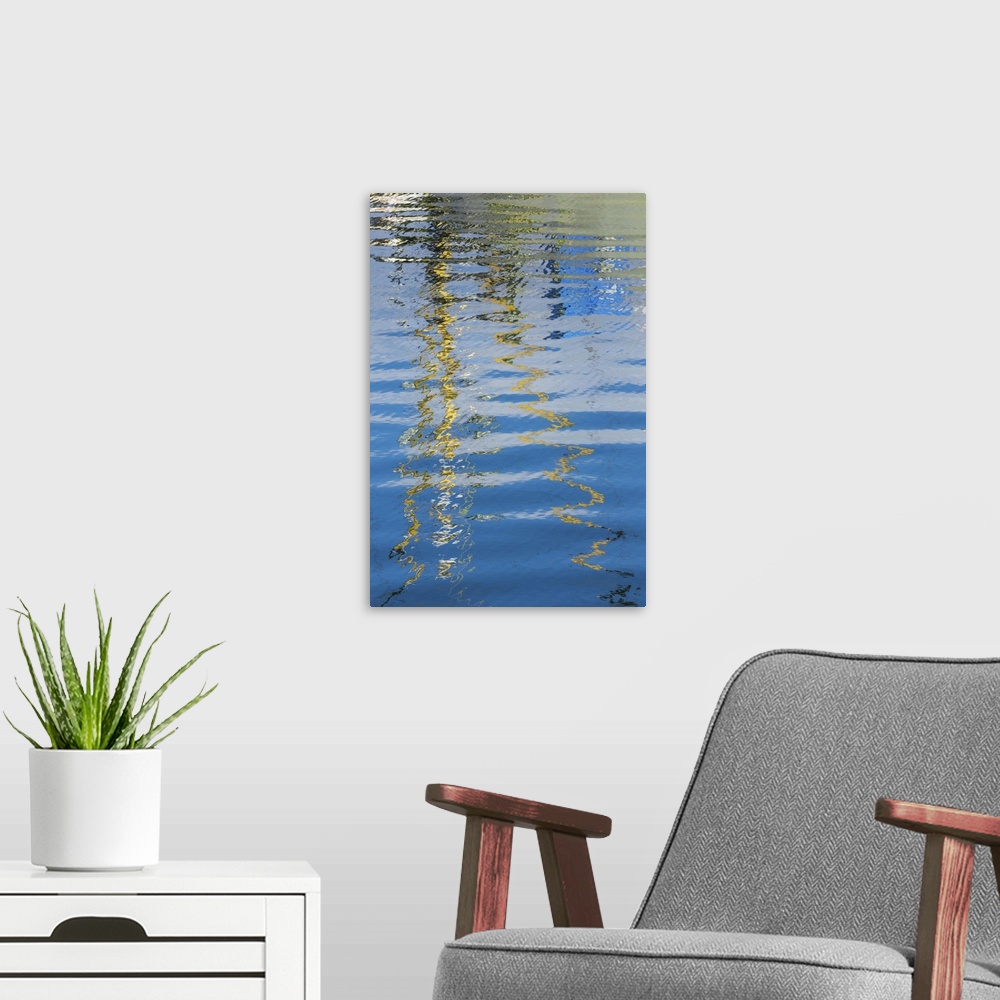 A modern room featuring Reflection of a boat on rippling water, creating an abstract image.