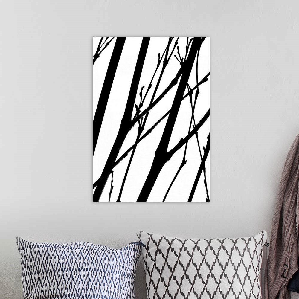 A bohemian room featuring Silhouettes of several thin branches on a white background.