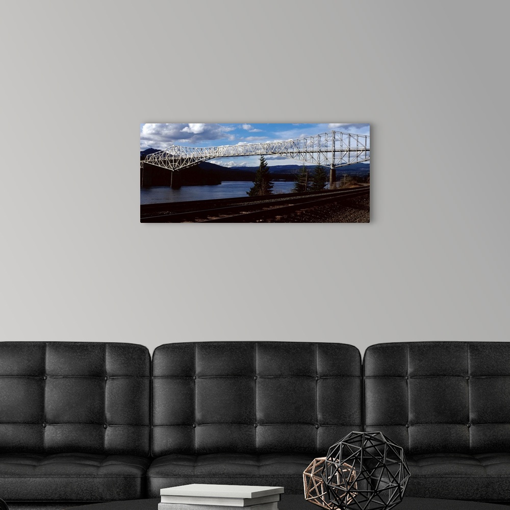 A modern room featuring Photograph of the Bridge of the Gods over the Columbia River in Washington, with railroad tracks ...