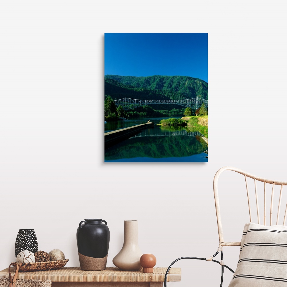 A farmhouse room featuring Photograph of the Columbia river with the Bridge of the Gods going over it and lush mountains in ...