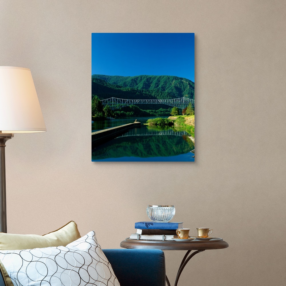 A traditional room featuring Photograph of the Columbia river with the Bridge of the Gods going over it and lush mountains in ...
