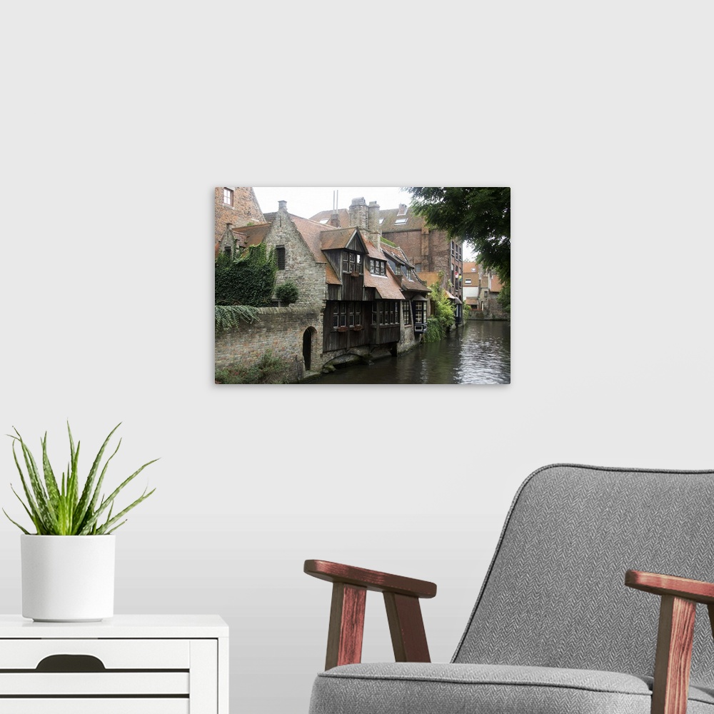 A modern room featuring Photograph of old houses on the edge of the river in Belgium.