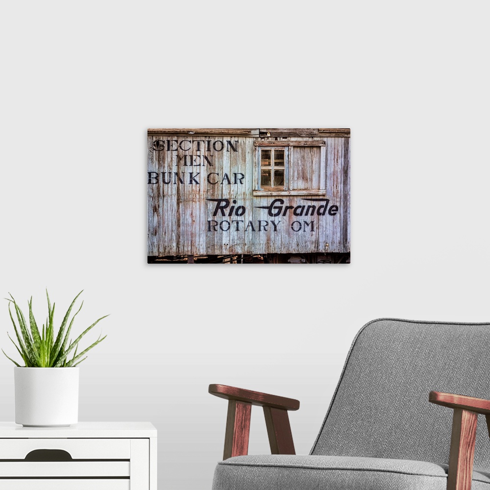 A modern room featuring Close up photo of detail and lettering from a vintage train car.